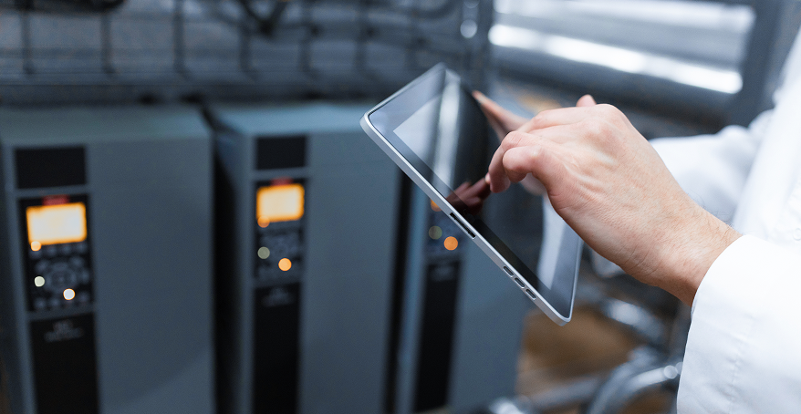 Technologist configuring equipment on a tablet in a plant