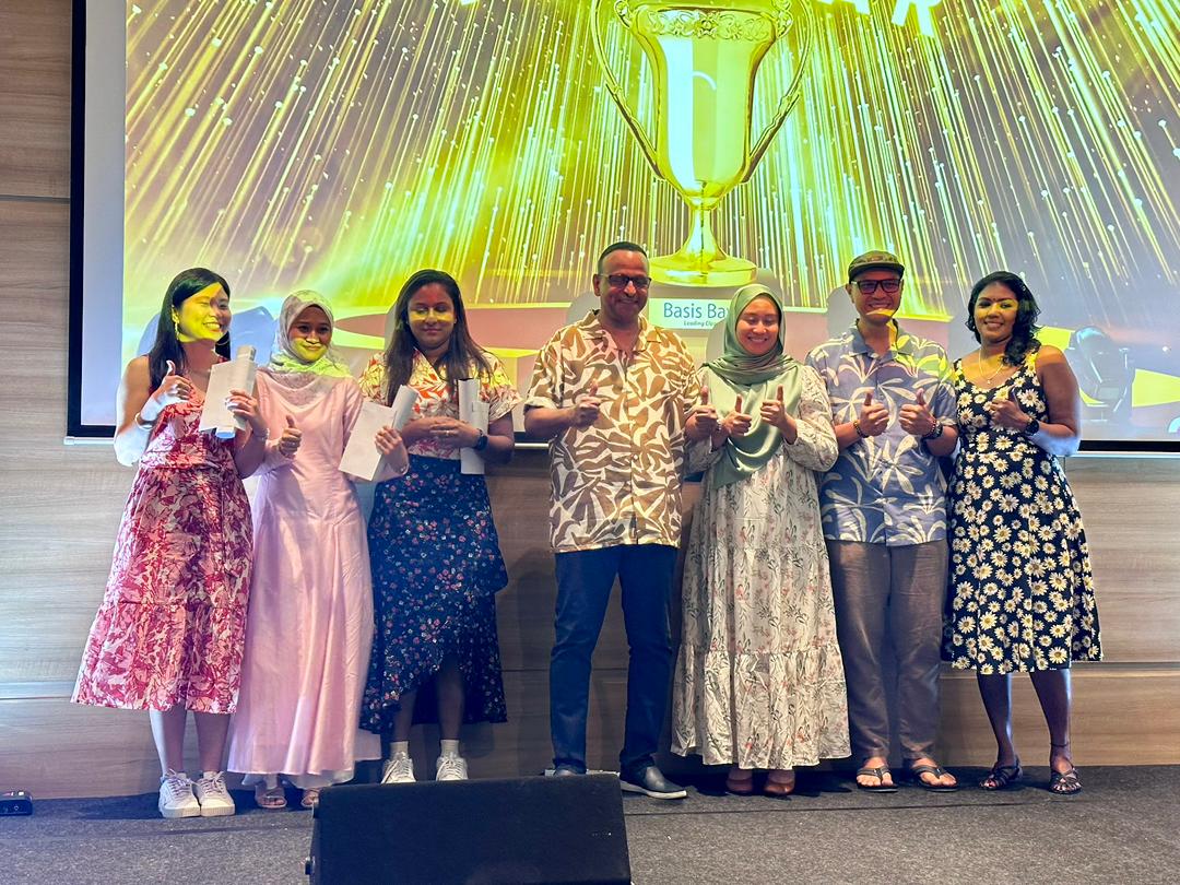 Employees receiving awards on stage at a Basis Bay ceremony